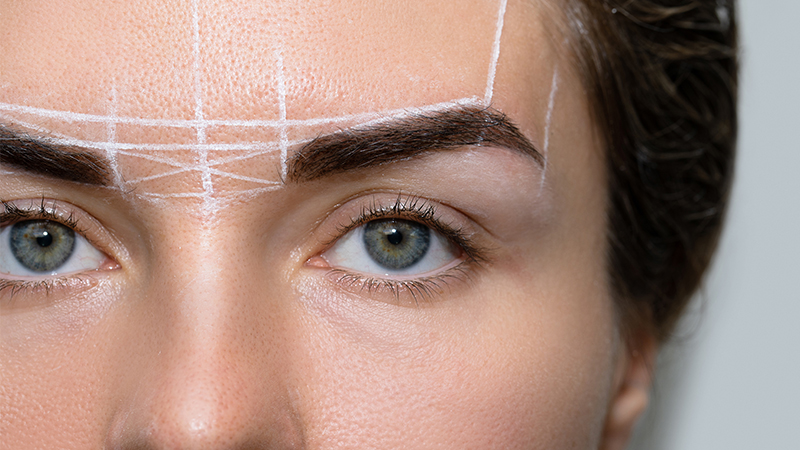Woman during professional eyebrow mapping procedure. Brow lift concept.