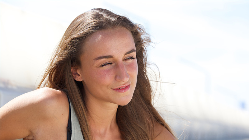 A teen girl with clear skin, thanks to AviClear Acne Treatment.
