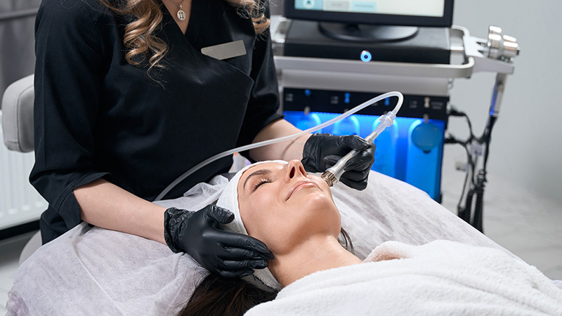 A woman receiving a Hydrafacial treatment.