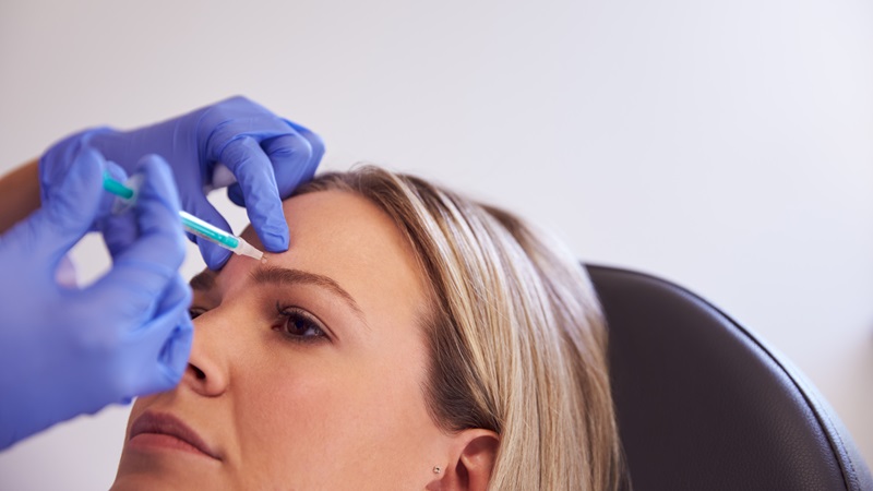 A woman receives Botox.